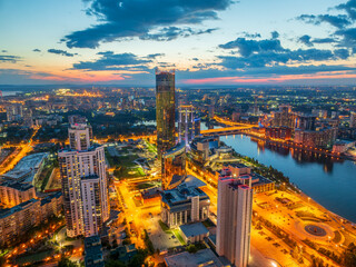 Obraz premium Yekaterinburg city and pond aerial panoramic view at summer or early autumn night. Night city in the early autumn or summer.