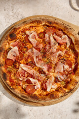 Delicious Meat Pizza with Bacon and Salami in Summer Sunlight and Shadows