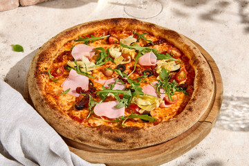 Sunlit Pizza with Mortadella, Artichokes, and Arugula in Summer Setting with Shadows