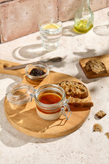 Rustic Chicken Pate with Crostini and Onion Marmalade on Wooden Platter in Sunlit Kitchen