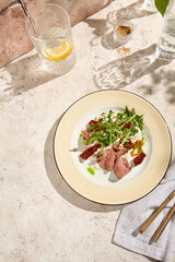 Delicious Roast Beef Salad with Arugula, Sun-Dried Tomatoes, and Cheese Mousse in Sunlit Still Life