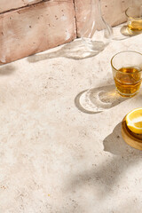 Sunlit Still Life with Lemon and Glasses on Natural Textured Table