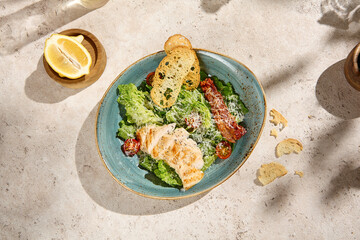 Authentic Caesar Salad with Chicken Fillet, Natural Light Still Life on Beige Table