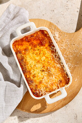 Authentic Sunlit Lasagna in Ceramic Dish A Still Life Table Scene with Natural Texture and Aesthetic Charm