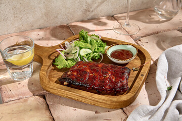 Rustic BBQ Ribs with Sauce and Fresh Green Salad in Sunlit Setting - Authentic Still Life