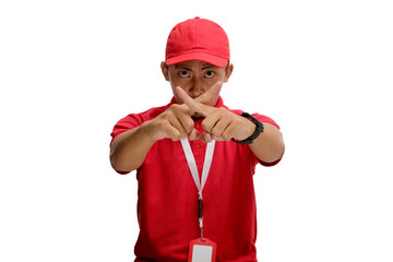 Asian delivery man is signaling for silence by crossing his fingers over his lips, indicating to stop talking or remain mute about limited special offer or discount. Isolated on white background