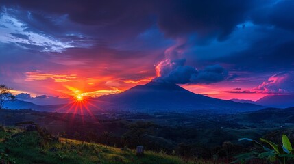 The dramatic beauty of a sunset over a volcano, the sky ablaze with color as the sun sets behind the peak, highlights nature's power and beauty.
