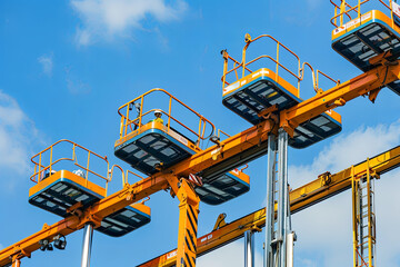 Fototapeta premium Several boom lifts in action