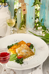 Sumptuous Breaded Sudak with Gratin Potatoes in Bright Sunlit Wooden Setting