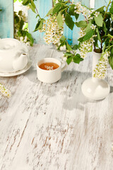 Summertime Floral Tea Setting with Sunlit Wooden Background