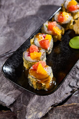 Elegant Mango and Grapefruit Tempura Sushi Rolls on Black Slate