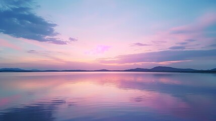 A peaceful lakeside view at sunrise, with calm waters reflecting the pastel colors of the sky.