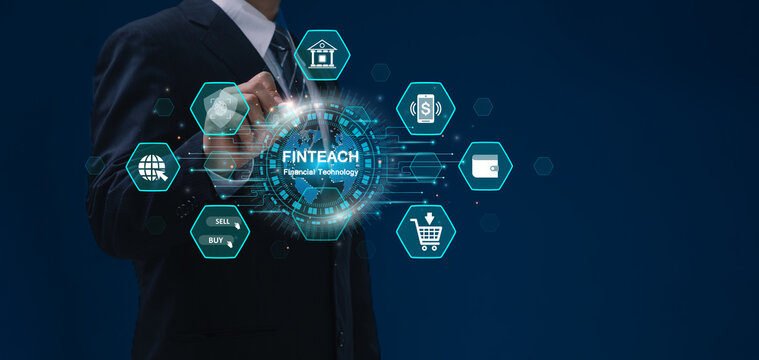 FinTech, Financial technology and Digital banking concept. Businessman interacting with a holographic globe representing fintech, surrounded by icons related to online finance. Mobile banking.