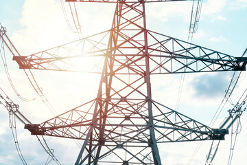 Tall Steel Power Transmission Tower Against Cloudy Sky