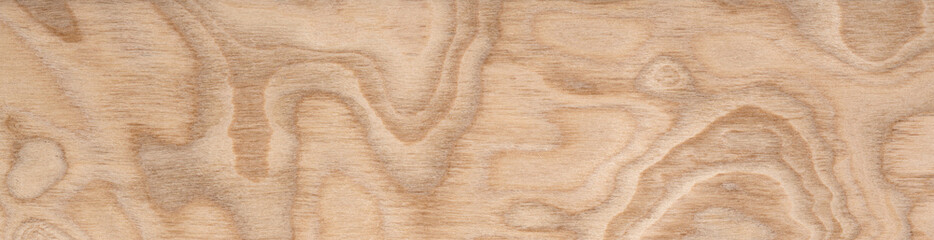 Swirling golden patterns and contours on a smooth plywood veneer surface