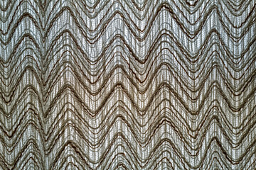 Fototapeta premium A contemporary cloth curtain hanging backlit in the window