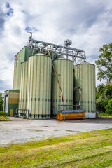 Obraz premium Grain silos with seeds cleaning line on agro-processing manufacturing plant for processing, drying, cleaning and storage of agricultural products