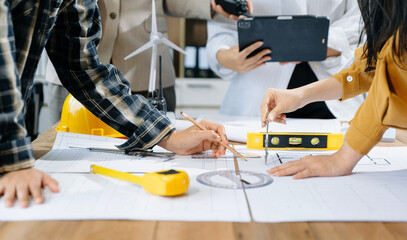 Engineer teams meeting working together wear worker helmets hardhat on construction site