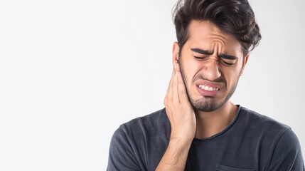 A man with a toothache, holding their cheek in pain