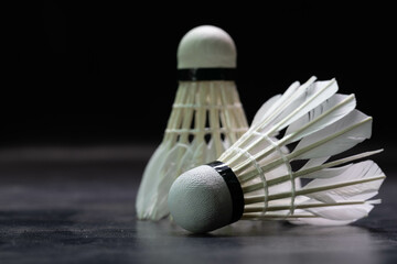 Close-up shot of badminton shuttlecock on black background used in competition.
