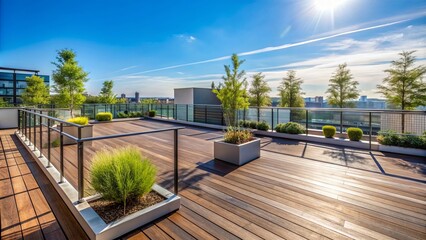 Obraz premium Sleek, modern, empty rooftop garden with sparse potted greenery, wooden flooring, and sleek metal railings against a clear blue sky.