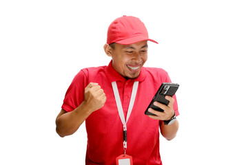 Excited Asian delivery man or courier feeling surprised after winning a prize for free delivery on a limited offer, as seen on his phone. Isolated on a white background
