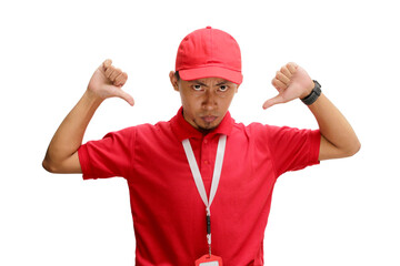 Displeased Asian Delivery man or courier is showing a thumb down gesture, giving bad review, low rating, feedback. Isolated on a white background
