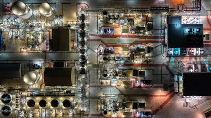 Aerial view oil and gas refinery at night, Business petrochemical industry refinery oil and gas factory power and fuel energy, Oil and gas storage tank fuel refinery industry at night.