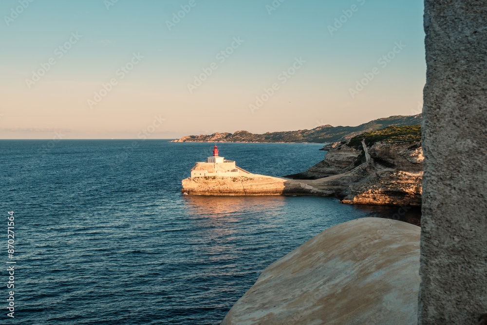 Sticker early morning sun on phare de la madonetta, a lighthouse on a limestone promontory at the entrance t