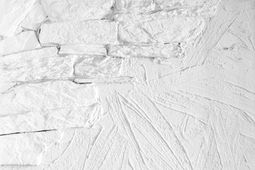 White wall with decorative stucco and bricks relief pattern. Front view