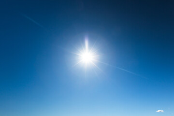 Fototapeta premium Deep blue sky with glowing sun, natural background photo