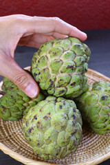 Obraz premium Heap of Ripe Organic Sugar Apples (Annona Squamosa) Whole Fruits in a Basket