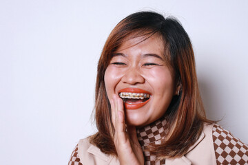 Smiling Face Of Happy Asian Adult Woman With Braces Isolated On White Background