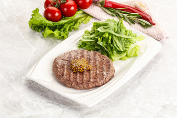 Frilled beef burger cutlet with iceberg
