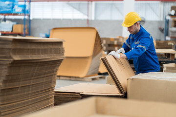 Warehouse worker working in warehouse. Male worker inspecting quality of products in warehouse