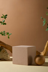 Unique nature concept photo with rock, wooden, log and green tree leaves, against the brown color background. An empty rectangular podium for product showing, blank space for text