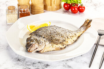 Baked Dorado fish served lemon