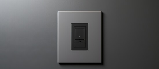 Modern technologies at home are showcased in the close-up of a grey wall featuring a black light switch, climate control panel with digital display, and providing a copyspace image.
