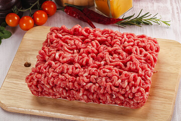 Raw minced beef meat over board