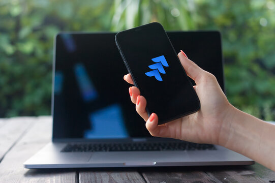 Jira logo, powerful project management tool by Atlassian for agile teams, offering tracking, planning, and collaboration features, displayed on iPhone screen