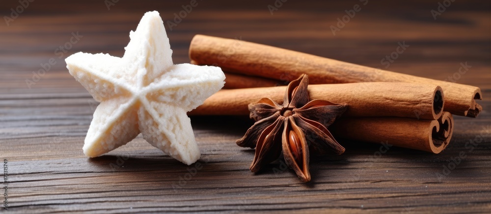 Poster A white star and a cinnamon stick rest on a wooden table with copy space image available.