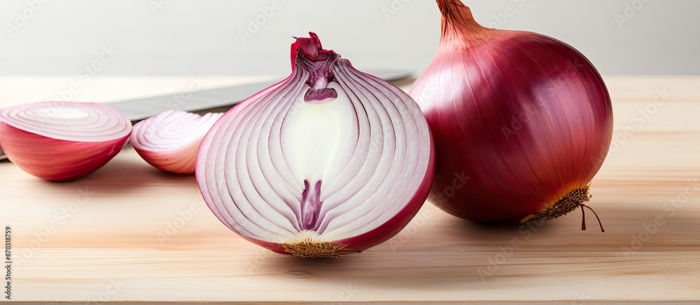 Poster Onion being sliced on a white wooden surface with background space available for your personal image. with copy space image. Place for adding text or design