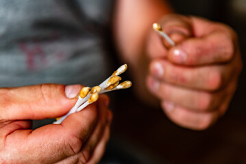 Man cleaning his ears with cotton swabs.