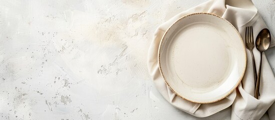 White table indoors with an empty plate, napkin, and copy space image available.
