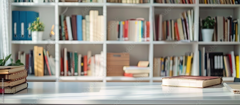 Poster An image of a white table in a blurry study room with books, stationery, and space for text or graphics. with copy space image. Place for adding text or design