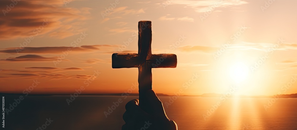 Poster a person praying and holding a christian cross in worship with a sunset copy space image for a relig