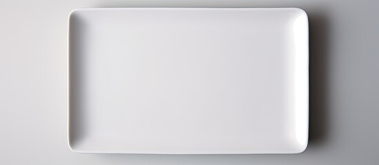 Rectangular white ceramic plate on a white backdrop with copy space image.