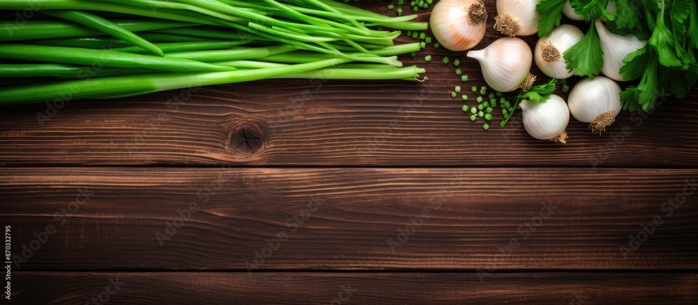 Aufkleber Top view flat lay showcasing fresh green onions and garlic on a wooden surface with available copy space image.