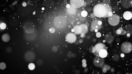 A black and white image of abstract white bokeh lights against a dark background