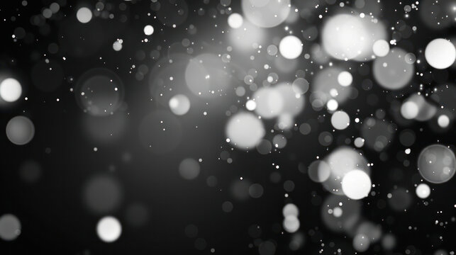 A black and white image of abstract white bokeh lights against a dark background